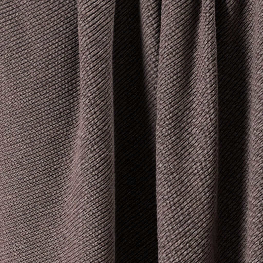 Close-up of the in2green 100% Merino Wool Links Throw Blanket in brown, featuring ribbed texture, diagonal patterns, and subtle shadows along its vertical folds.