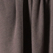 Close-up of the in2green 100% Merino Wool Links Throw Blanket in brown, featuring ribbed texture, diagonal patterns, and subtle shadows along its vertical folds.