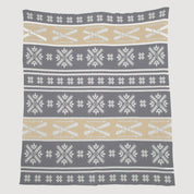The Fair Isle with Skis Throw Blanket by in2green exudes Swiss chalet charm, featuring snowflakes and crossed skis in white and beige against a gray backdrop.