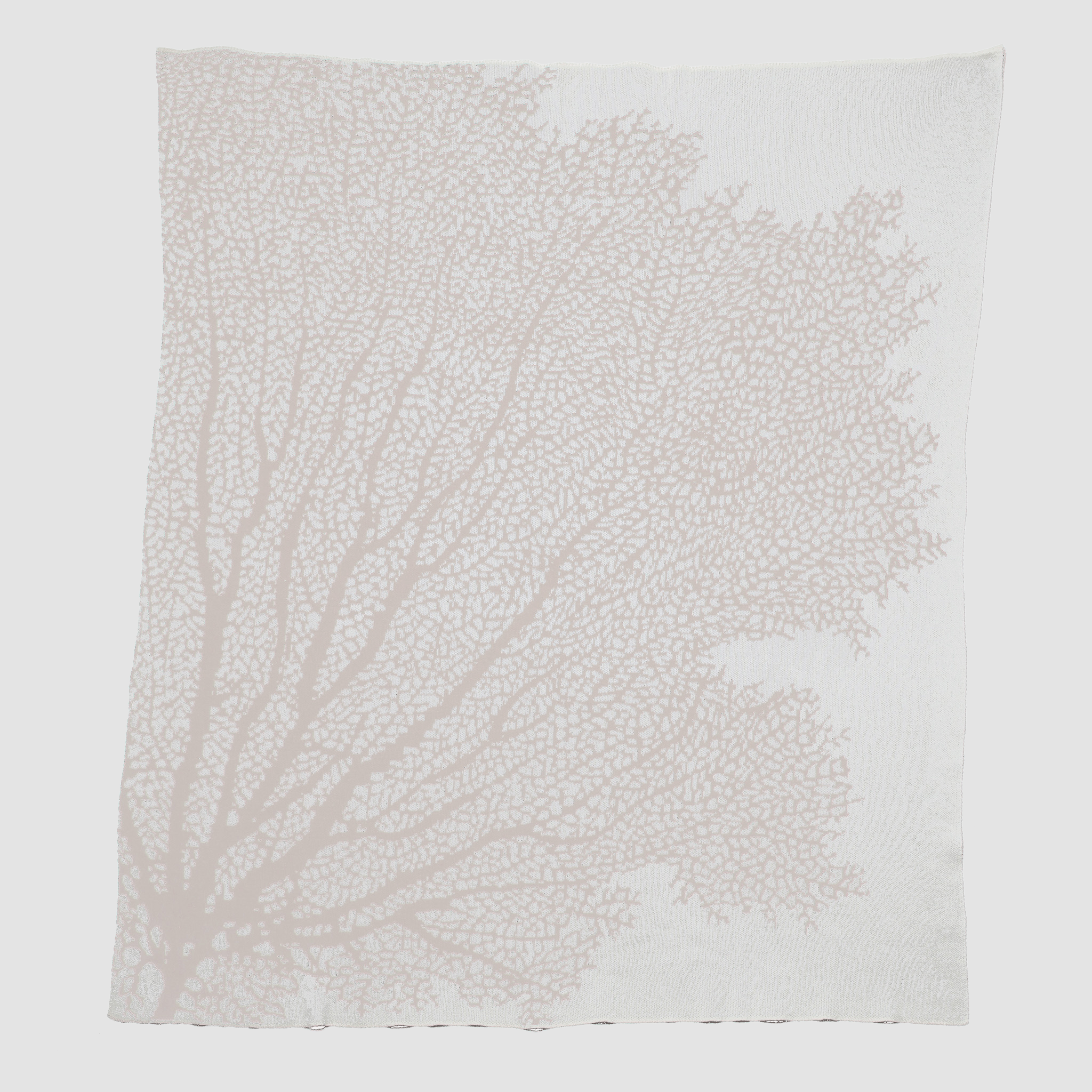 The in2green Fan Coral Throw Blanket features a white coral design with light pink branches, ideal for adding coastal charm to beach houses.