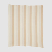 The Herringbone Hues Throw Blanket by In2Green is an eco-friendly creation made from recycled cotton, showcasing a square design with alternating vertical beige and tan stripes on a light background, proudly made in the USA.