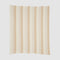 The Herringbone Hues Throw Blanket by In2Green is an eco-friendly creation made from recycled cotton, showcasing a square design with alternating vertical beige and tan stripes on a light background, proudly made in the USA.