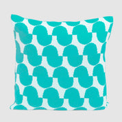 The Poly Juki Pillow by Petra Kaksonen for in2green features a Nordic-inspired turquoise geometric pattern on white and is made from recycled plastic bottles—an eco-friendly, stylish outdoor pillow.