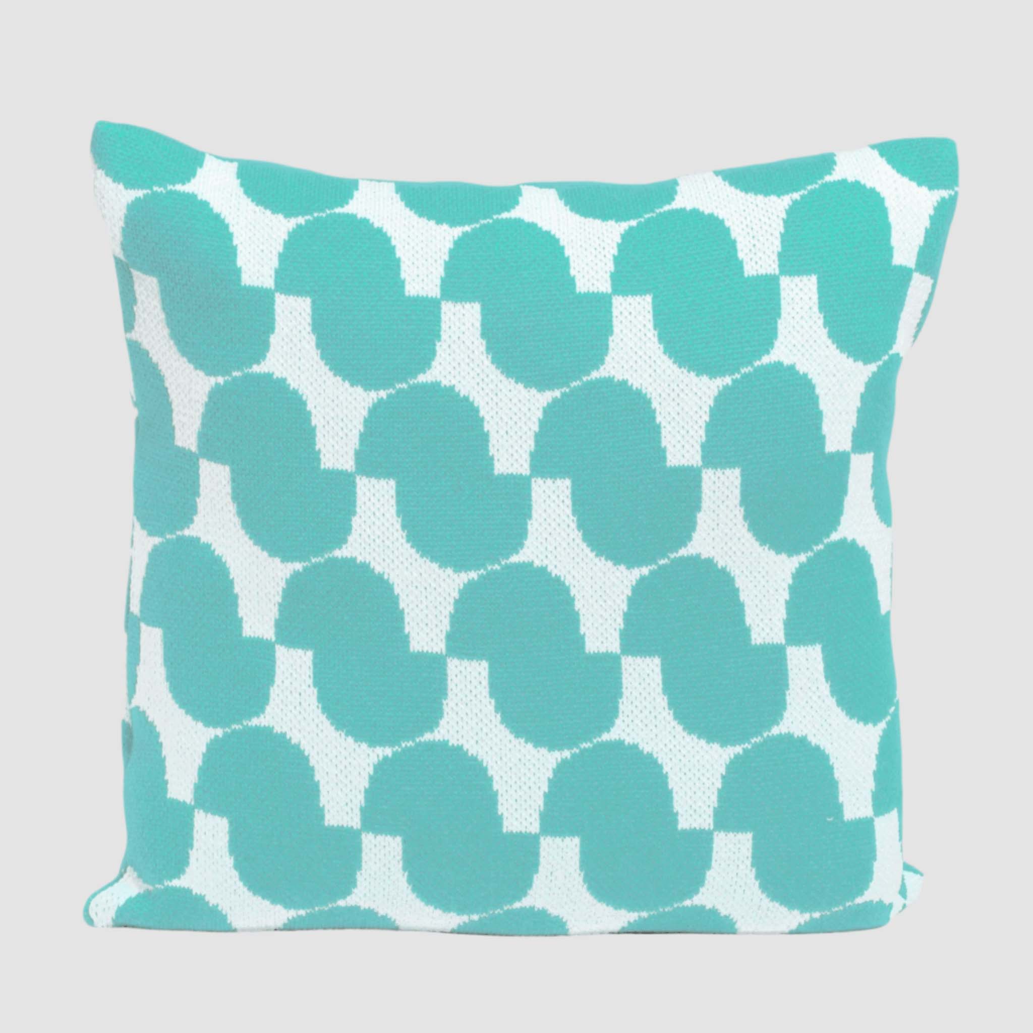 The Poly Juki Pillow by Petra Kaksonen for in2green features a Nordic-inspired turquoise geometric pattern on white and is made from recycled plastic bottles—an eco-friendly, stylish outdoor pillow.