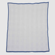 The in2green Poly Woven Square Throw Blanket features a blue border, white background, and repeating diamond pattern in durable outdoor fabric—ideal for elevating your outdoor space.