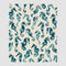 The Seahorse Watercolor Throw Blanket by in2green features blue textured seahorses on a light beige background, crafted from recycled cotton, showcasing sustainable elegance and drapable art.