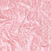 The In2Green Warrior Throw Blanket Pink boasts a striking zigzag pattern in red and white, with a gently crumpled texture, offering both comfort and style for individuals searching for warmth and supporting the breast cancer cause.