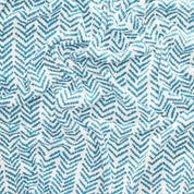 Close-up of a textured Warrior Throw Blanket Teal by In2Green, showcasing a teal and white zigzag pattern, offering comfort and unity to those in need of breast cancer support.